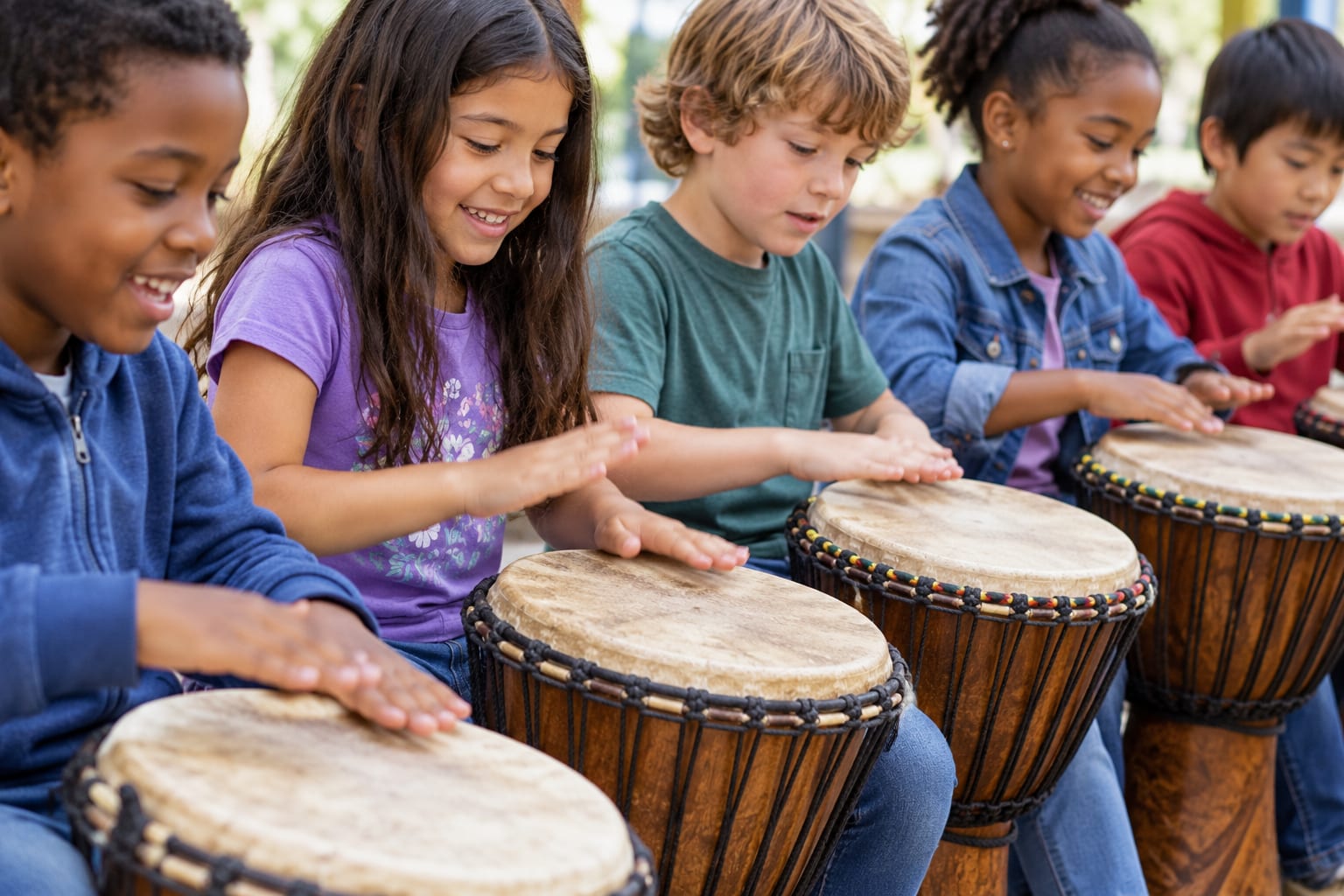 A student drumming with Mr. Max